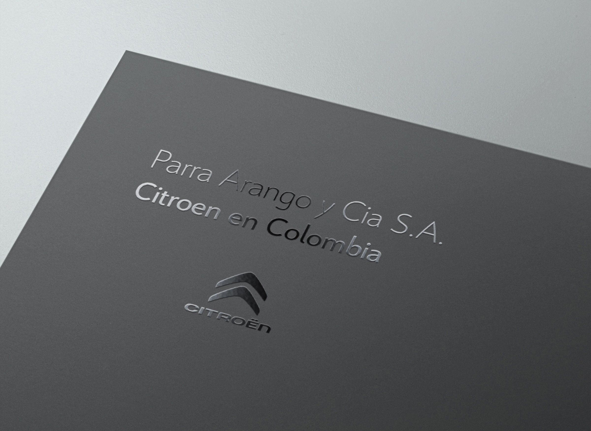 Dark grey cover with the chevrons and company name embossed in silver
