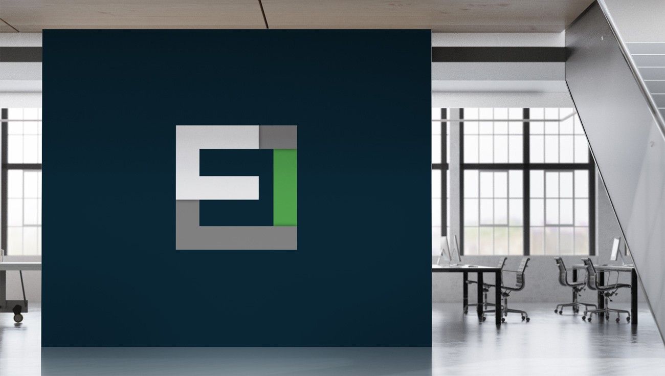 EC monogram on a navy feature wall in a bright office