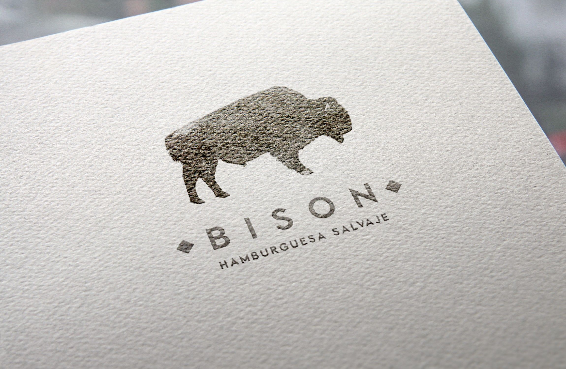 Bison logo printed in textured ink on natural paper