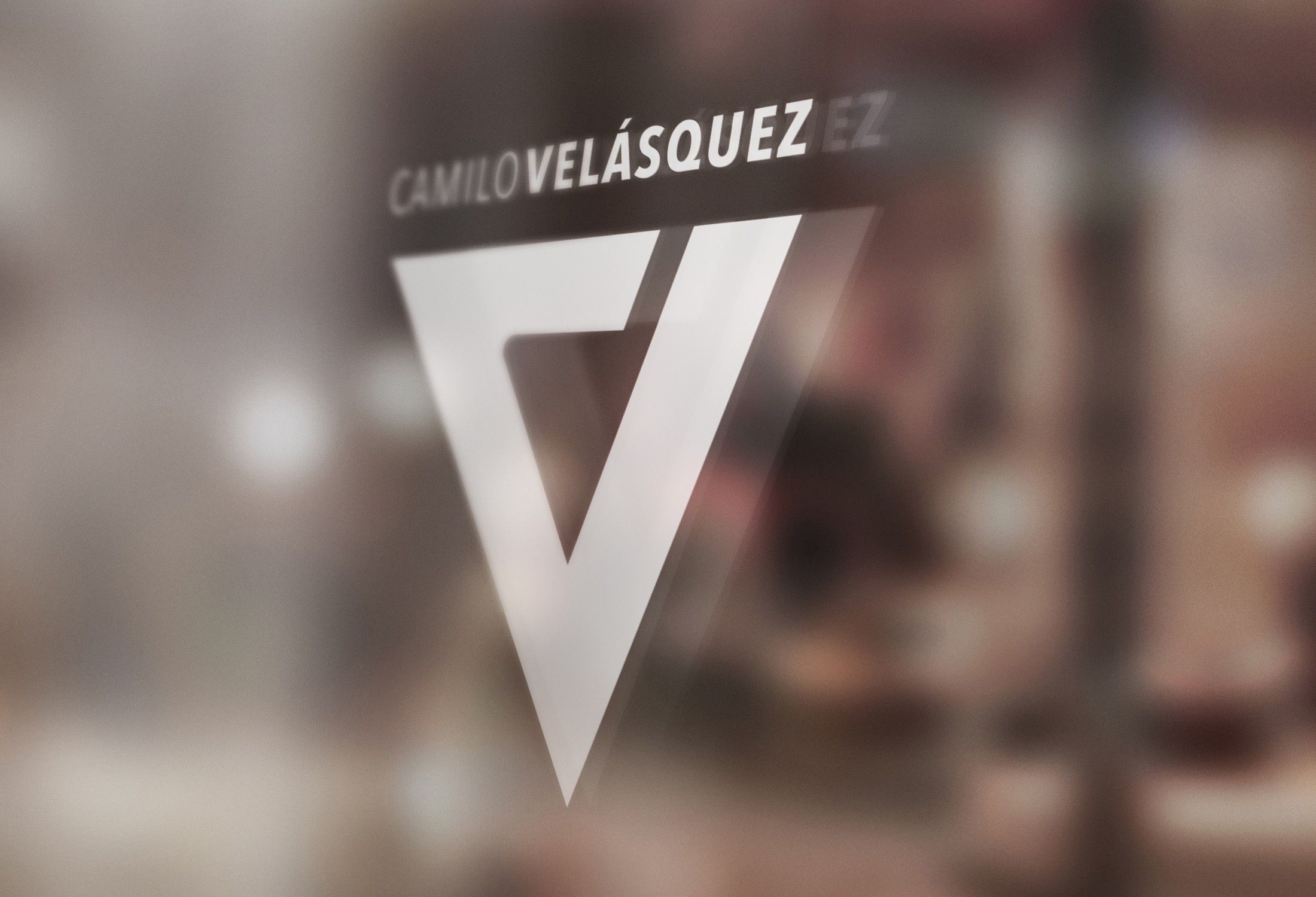 White V monogram and name on a frosted shop window