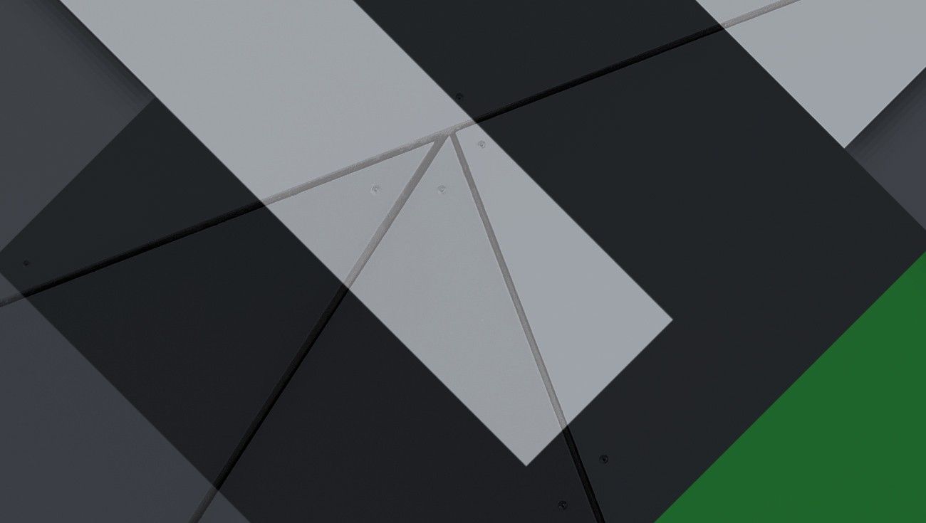 Brand pattern of angled grey, black and green shapes