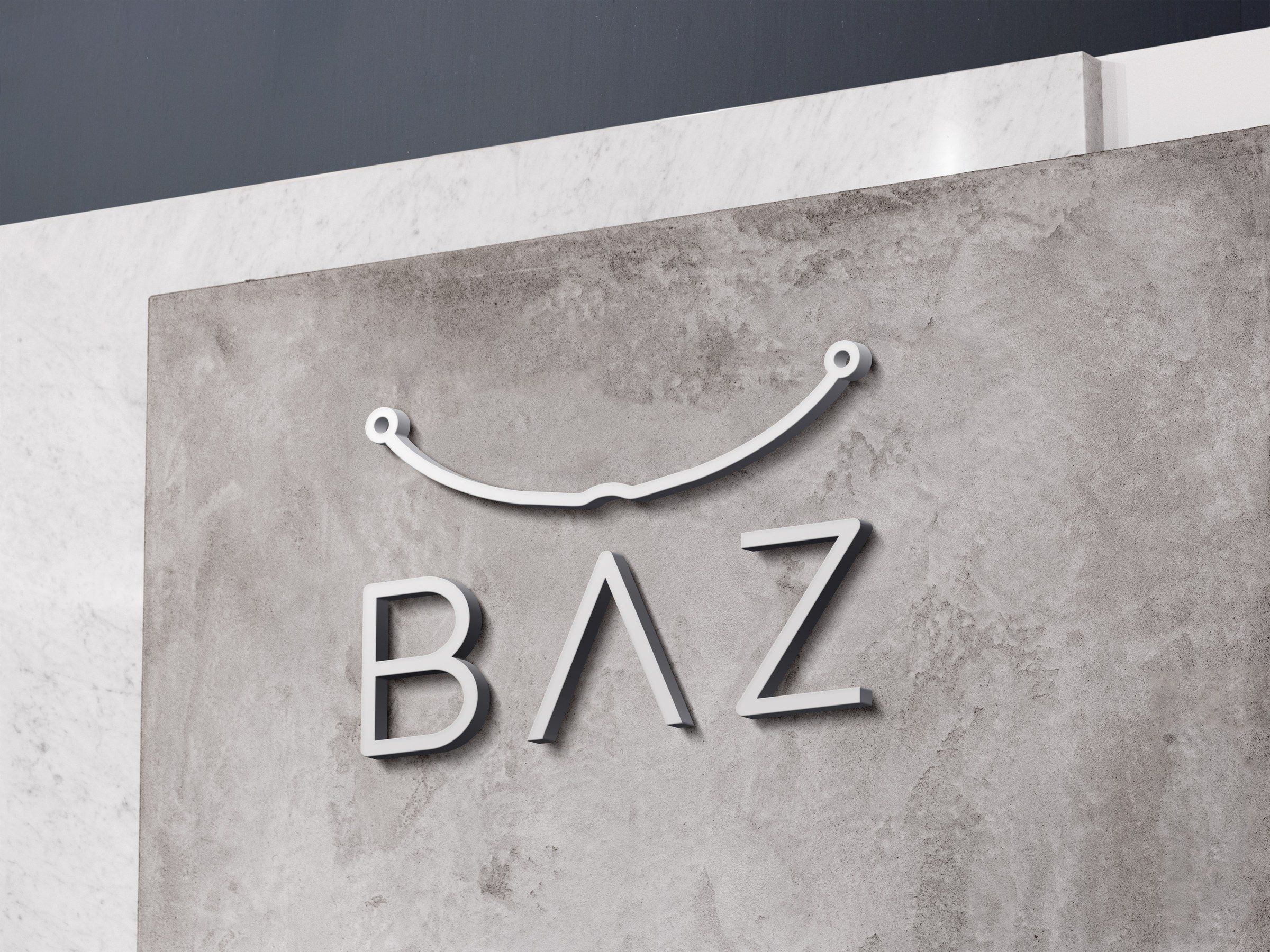 BAZ logo as raised white lettering on a concrete wall